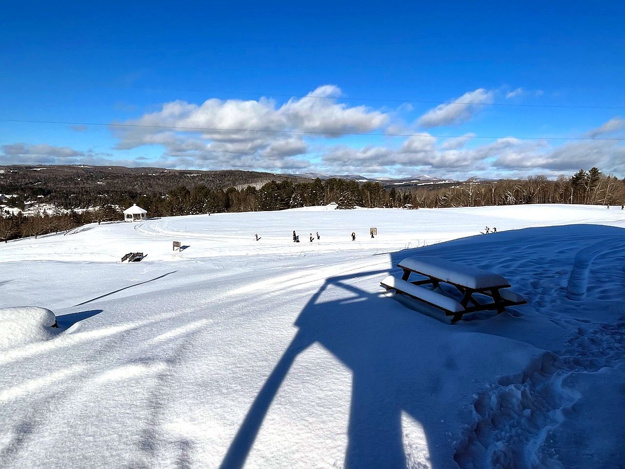 Snow-covered recreation field with blue sky and mountain views at the Wildflower Inn, Lyndonville VT