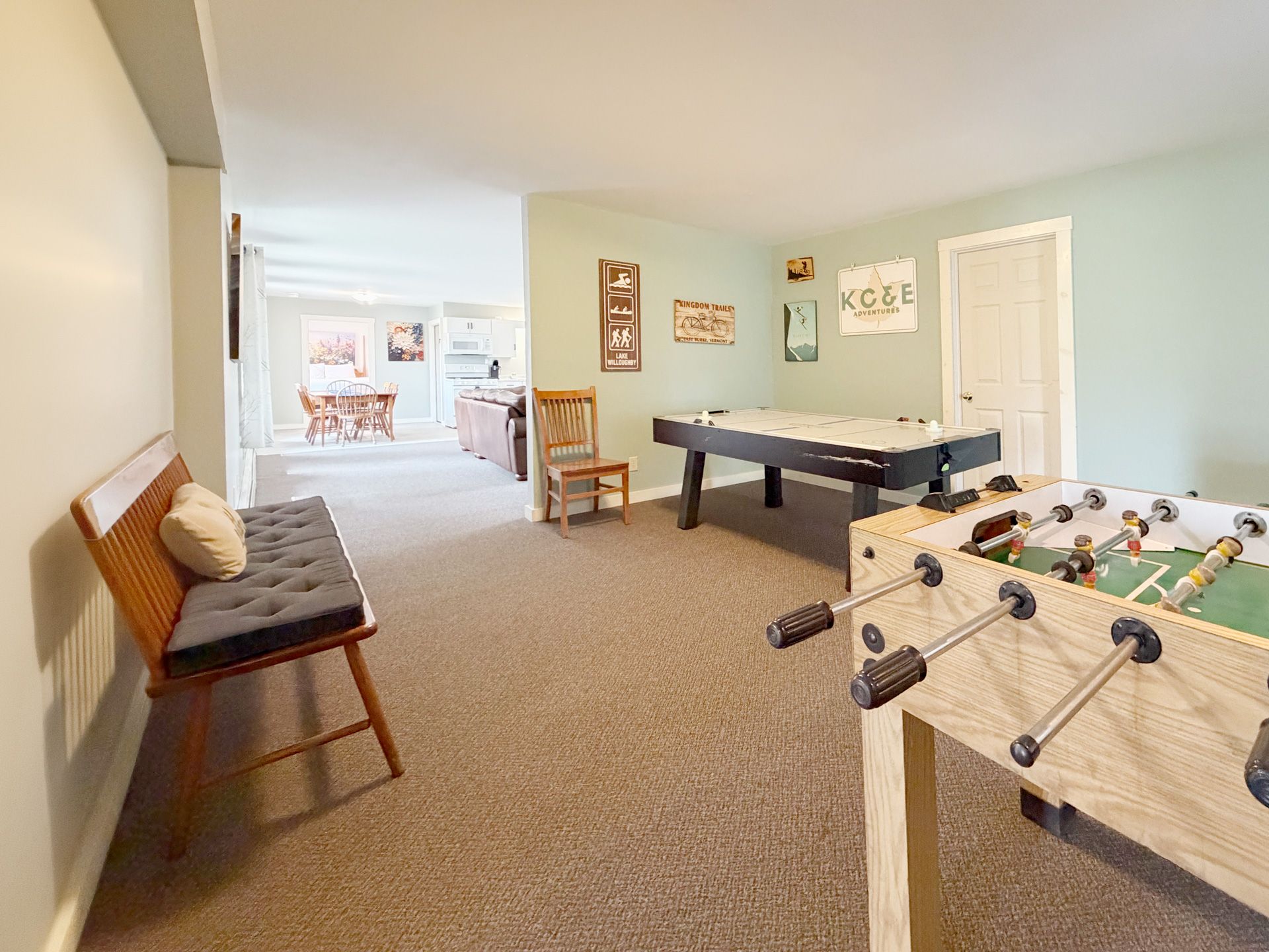 Basement rec room with pool table, foosball table, couch, and light blue walls