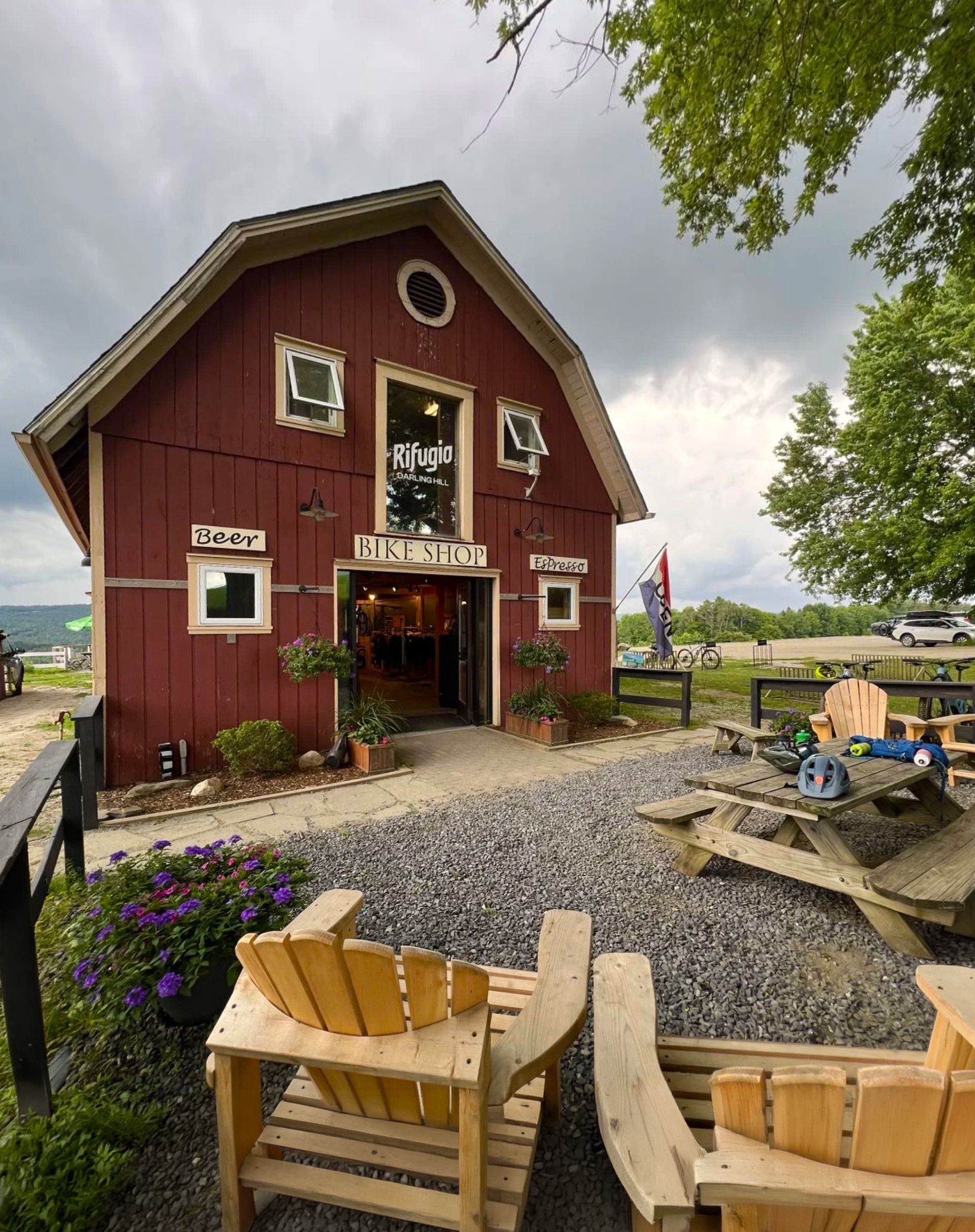 Rifugio bike shop in the red barn at the Wildflower Inn with beer and espresso signs, on the Kingdom Trails in East Burke Vermont