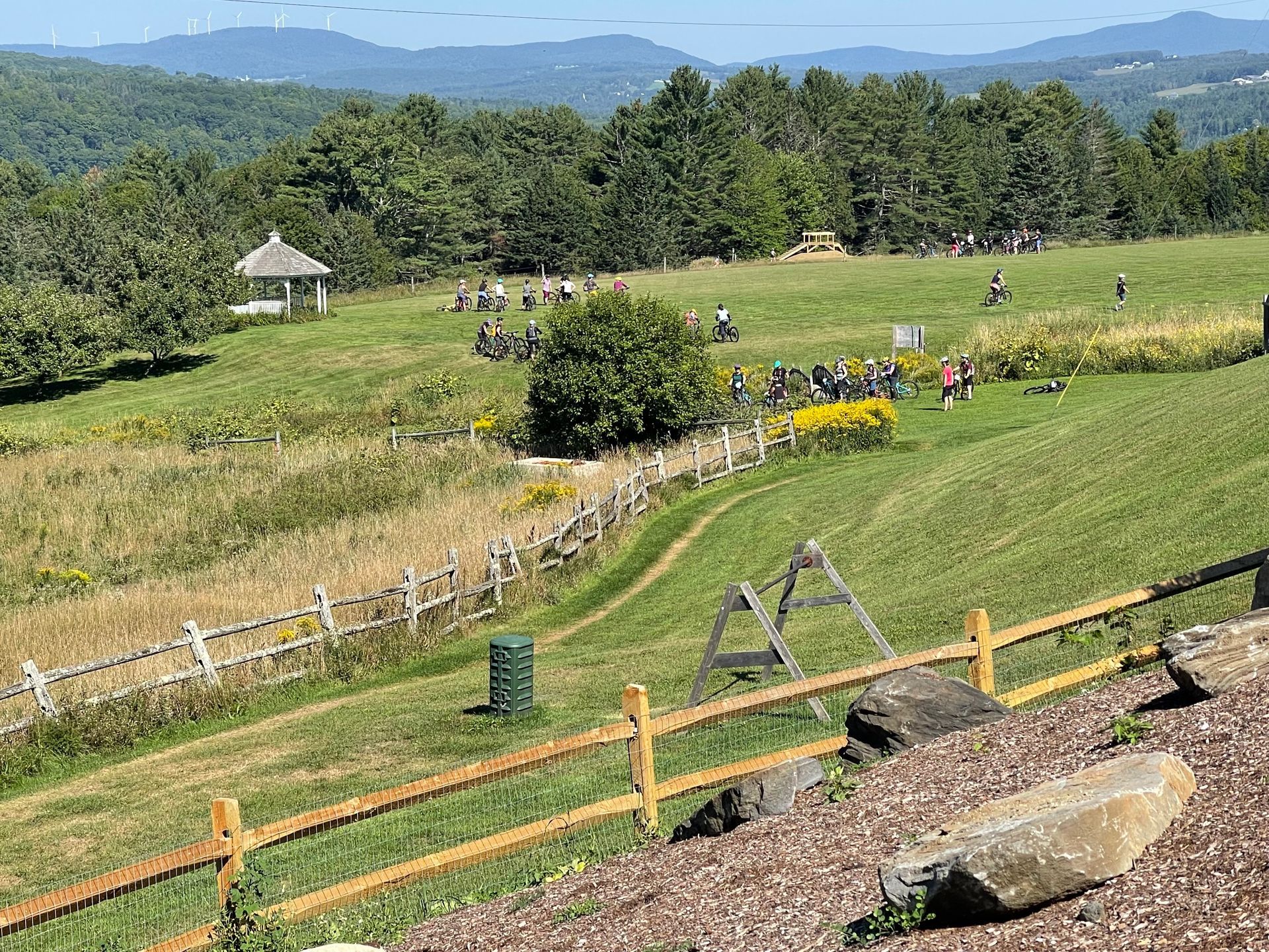Kids riding bikes at the skills park field and gazebo at The Wildflower Inn, home of Kingdom Bike Fe