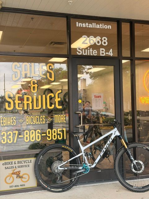 Mountain bike parked outside a storefront with “Sales & Service” signage and suite number 2688 B-4.