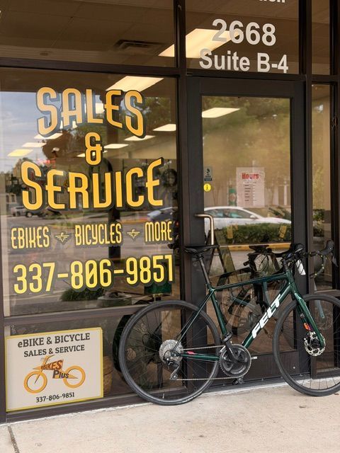 Bike shop storefront with yellow “Sales & Service” sign and bicycles parked outside