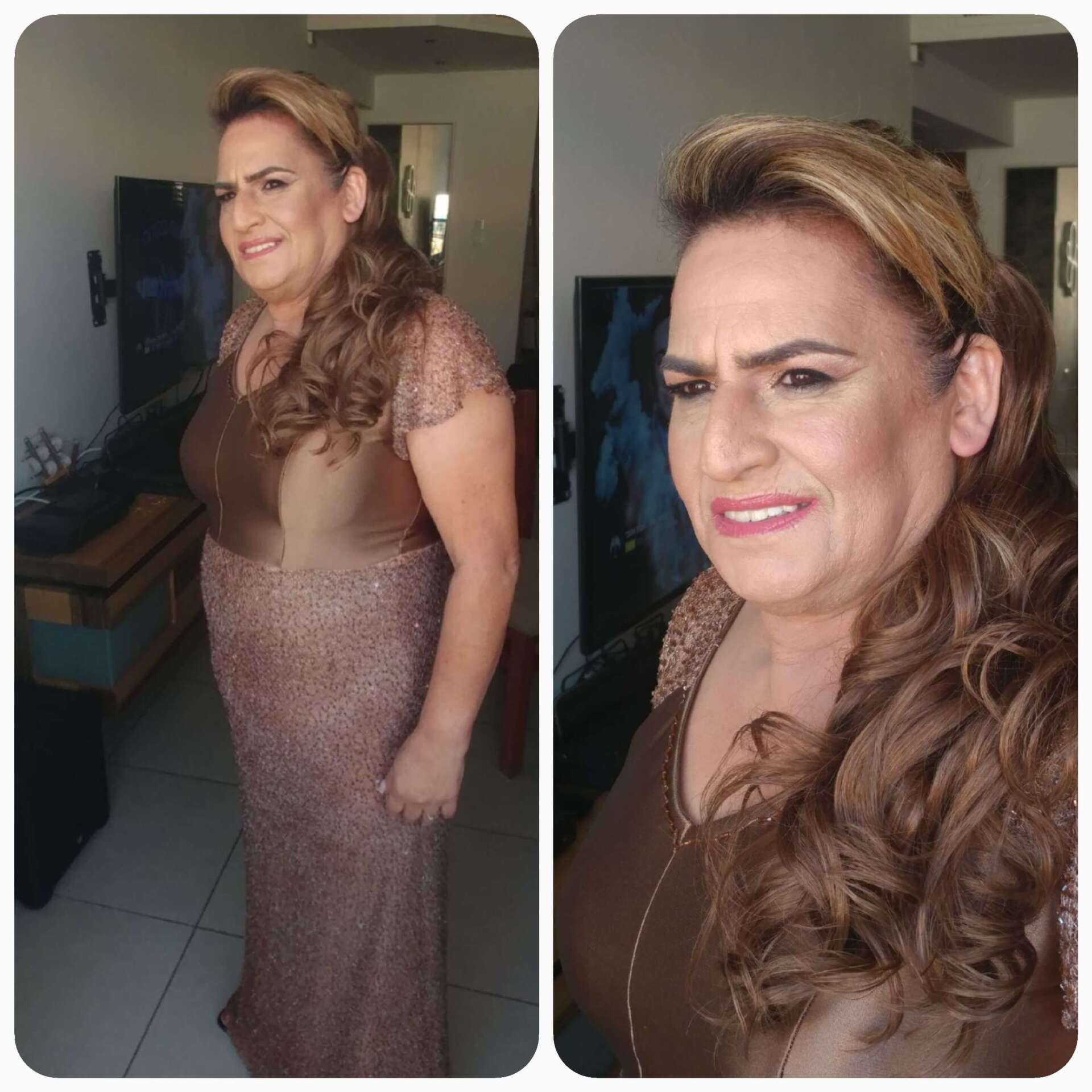 אישה בשמלה רשמית חומה, שיער חום גלי, נראית מעט לא מרוצה בתוך הבית.