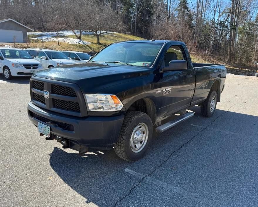 Black Ram pickup truck parked on asphalt.