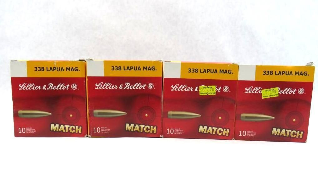 Four boxes of Lapua Match ammunition, red and white with gold bullets.