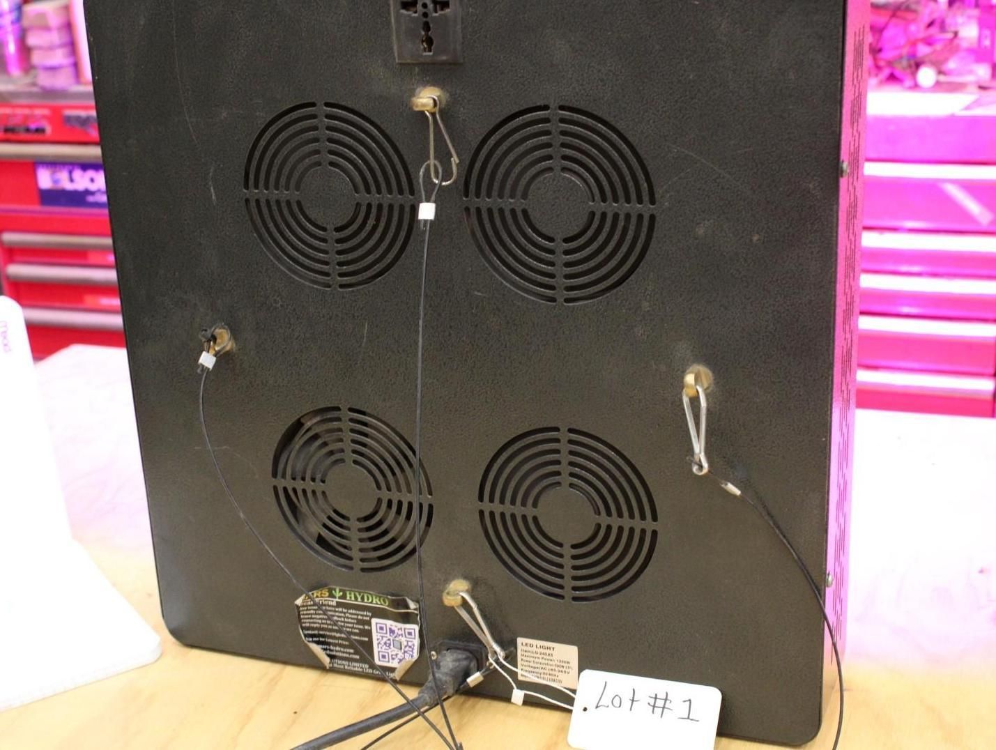 Back of a black grow light with four fans, power cord, and hanging wires.