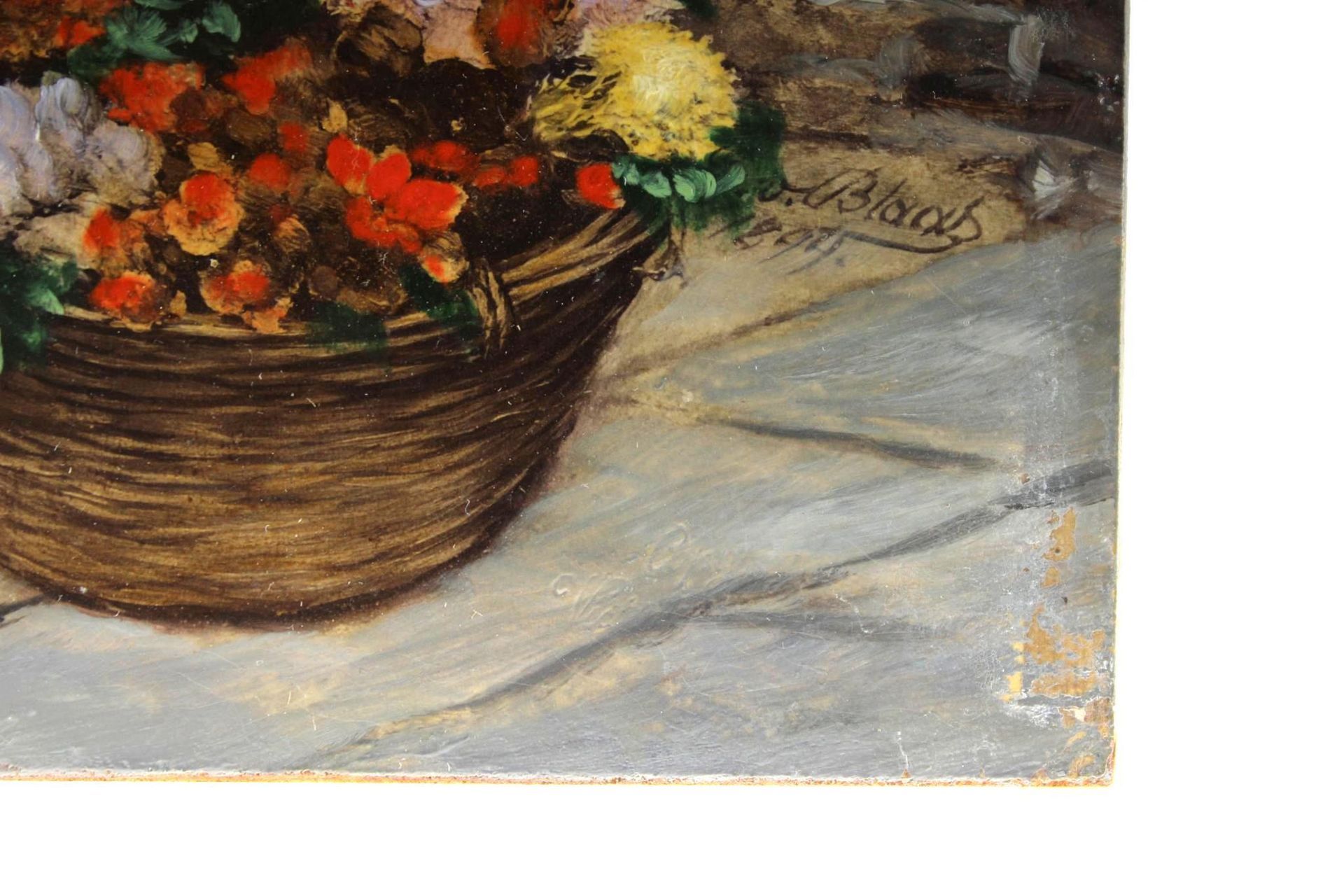 Basket of colorful flowers on a stone surface.