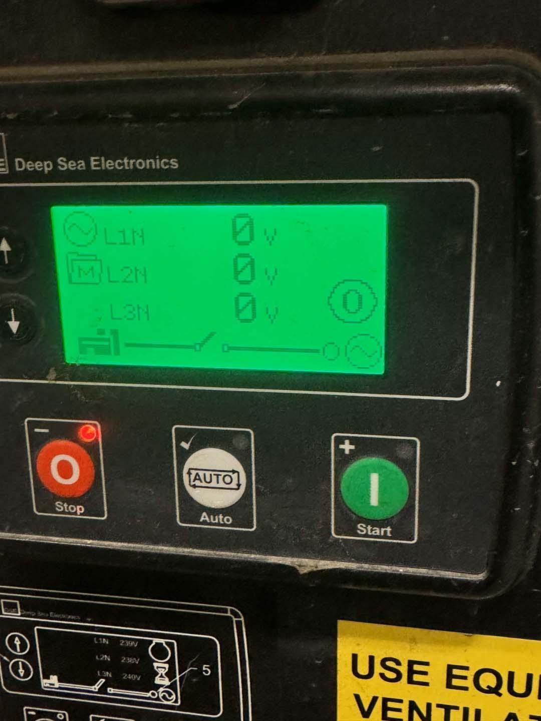 Green display panel with 0V readings, control buttons for stop, auto, and start. Deep Sea Electronics label.