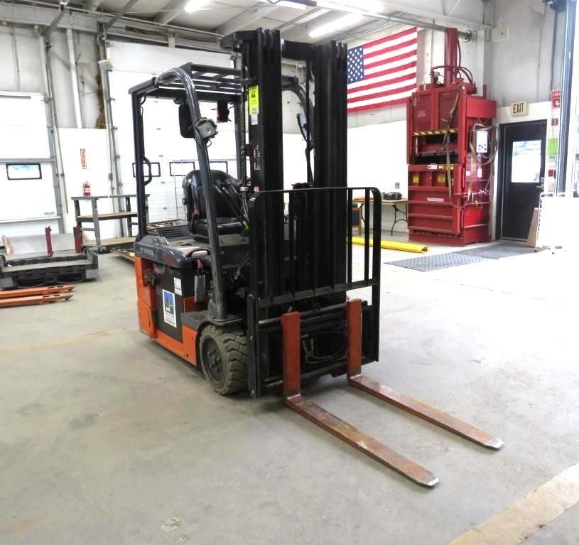 Forklift parked in a warehouse, with red and black accents.