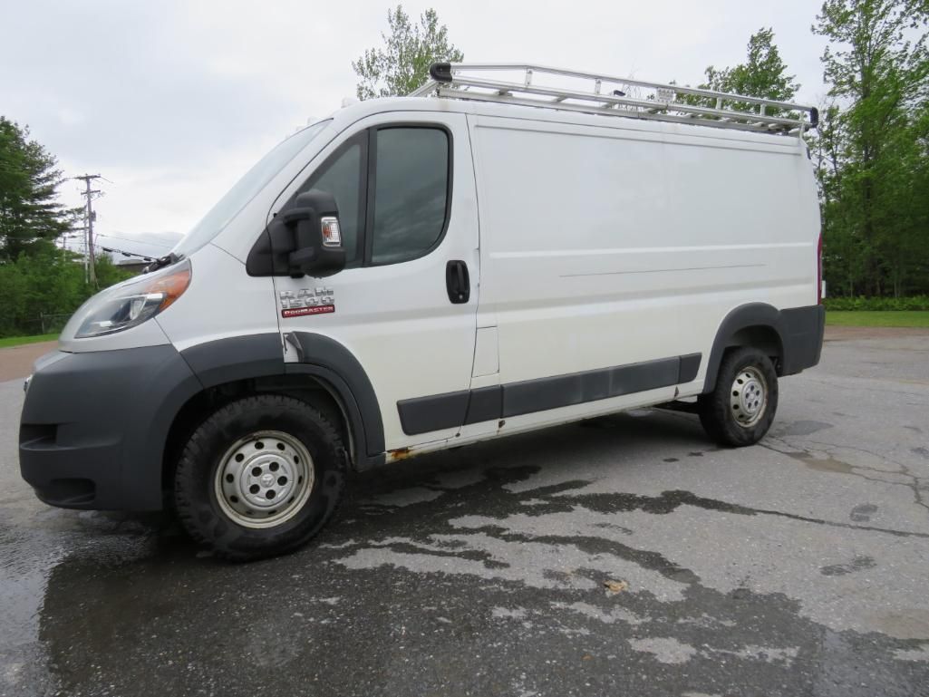 White Ram ProMaster cargo van with a roof rack parked on asphalt.