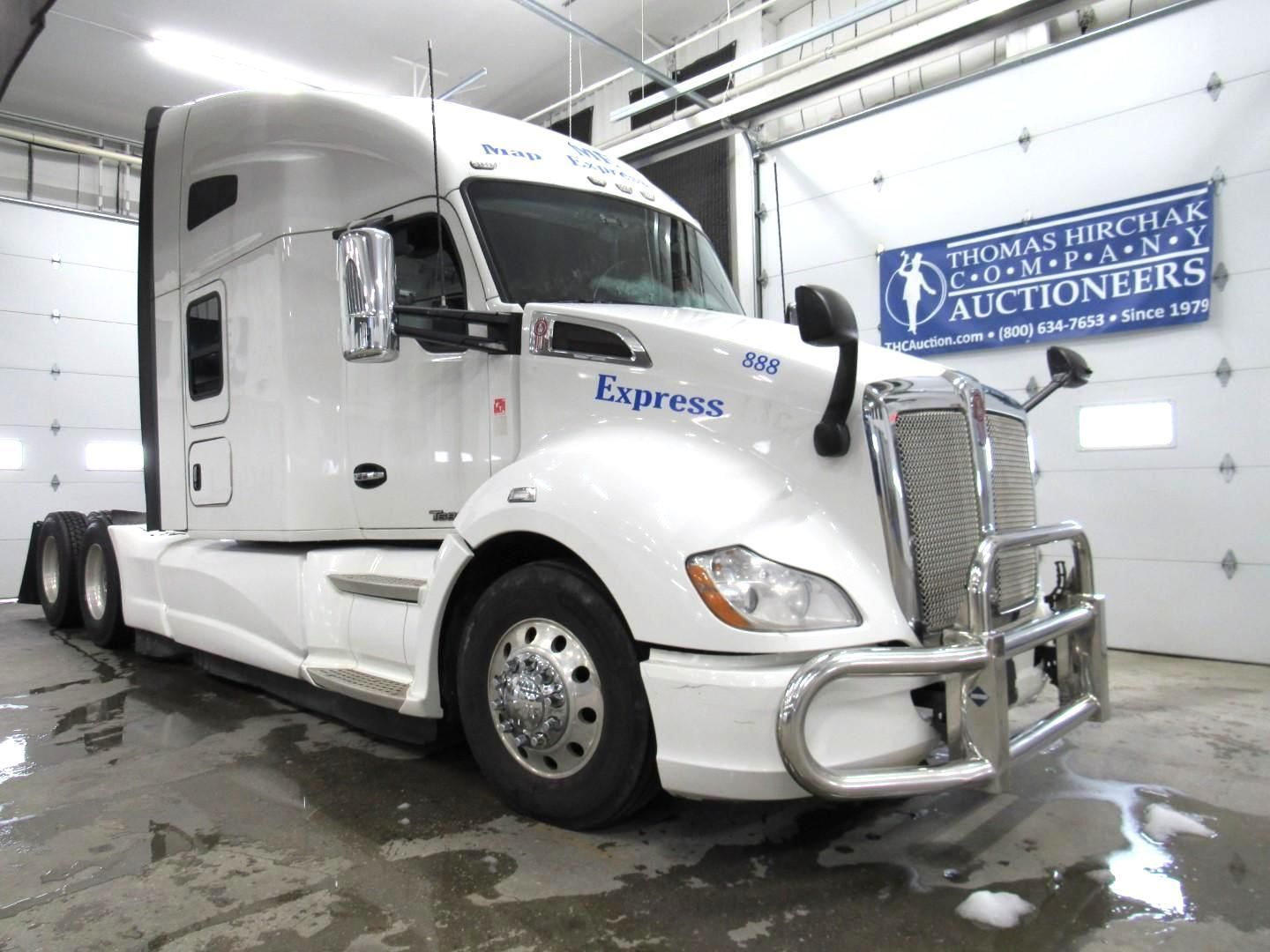 White Kenworth semi-truck with chrome bumper and