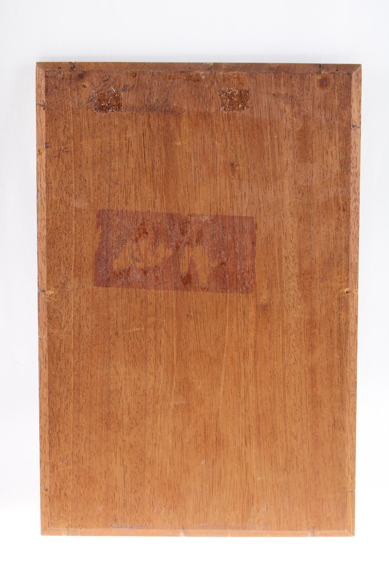 Wooden rectangular plaque with a faded, reddish-brown rectangular mark in the middle.