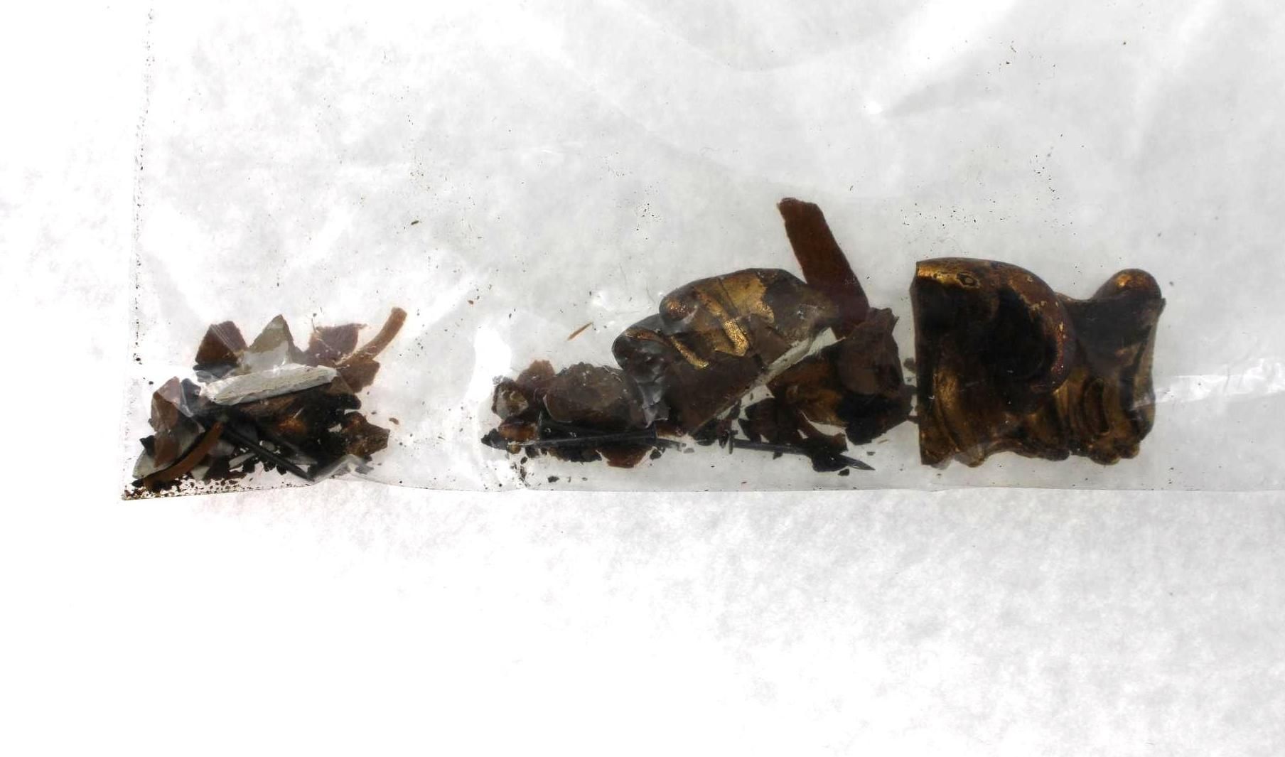 Brown, fragmented, metal fragments in a transparent bag.