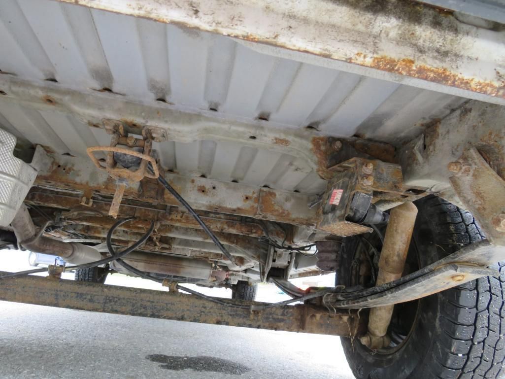 Underside of a vehicle, showing the frame, suspension, and undercarriage components.