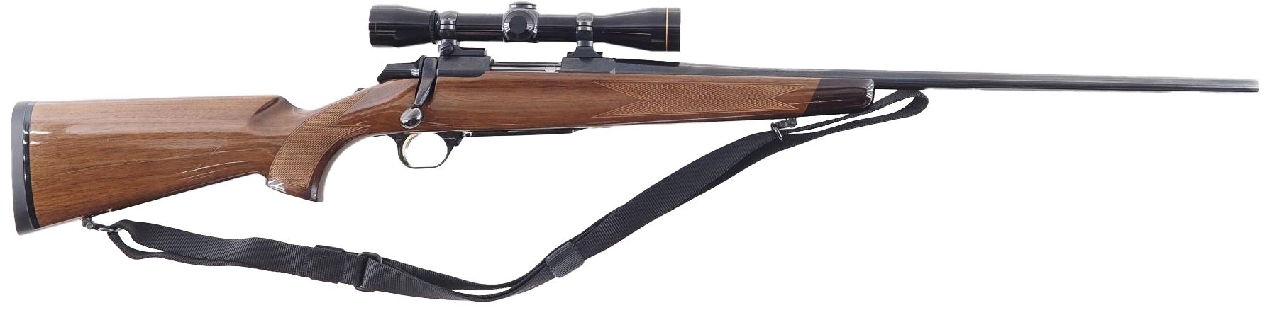 A brown rifle with a scope and a black strap, laying horizontally on a white surface.