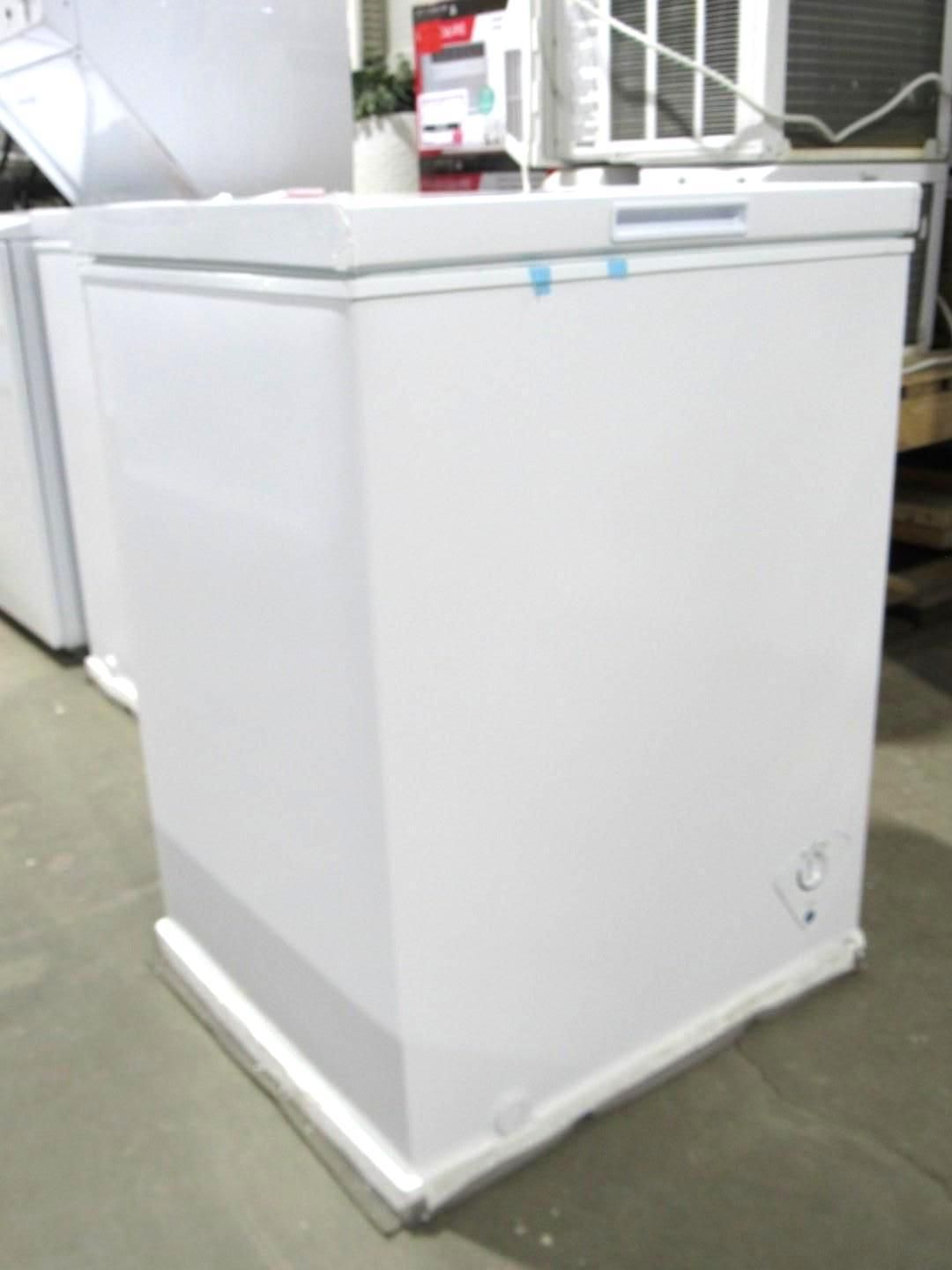 White chest freezer in a store setting.