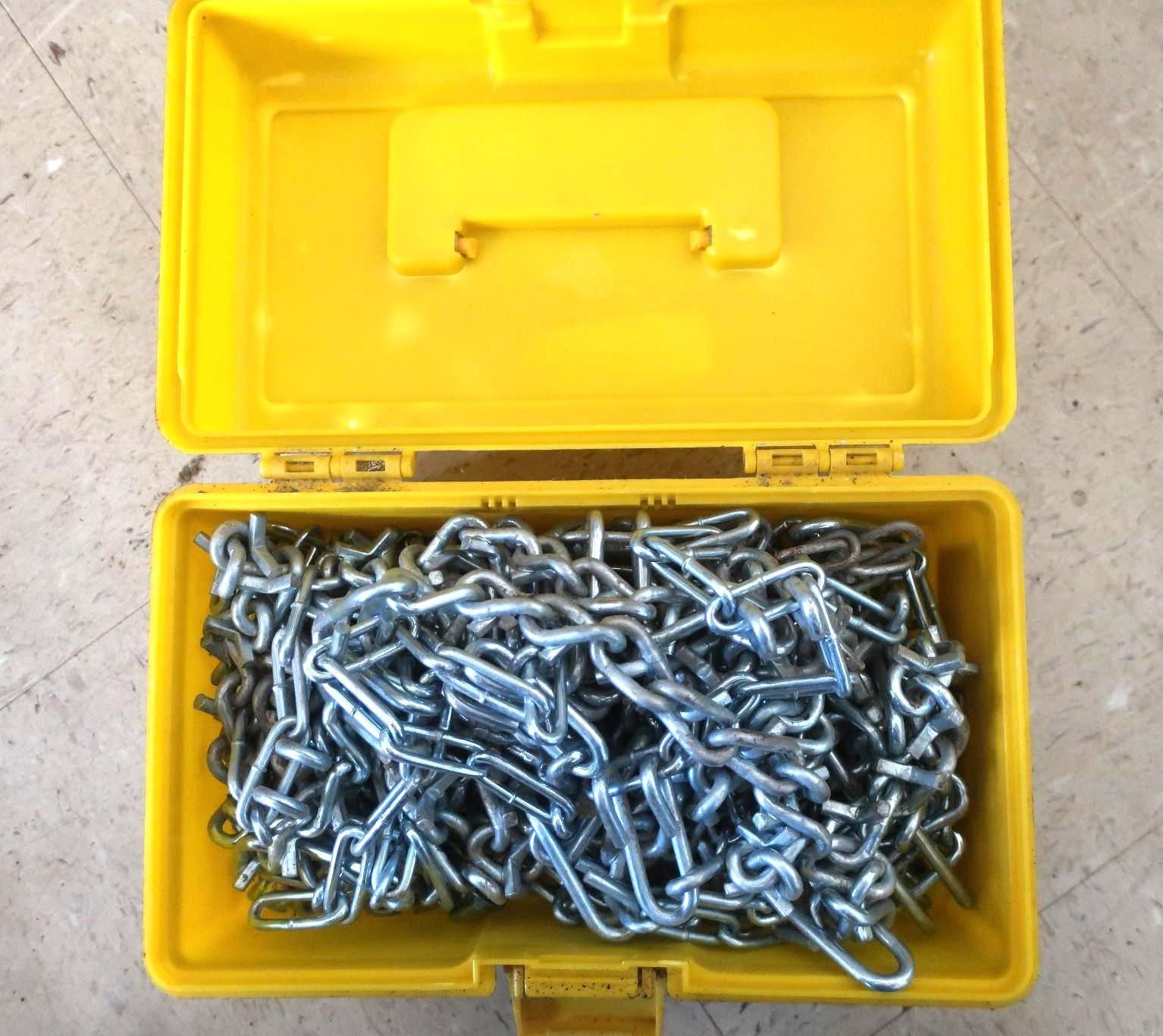 Yellow toolbox open, filled with a pile of silver metal chain.