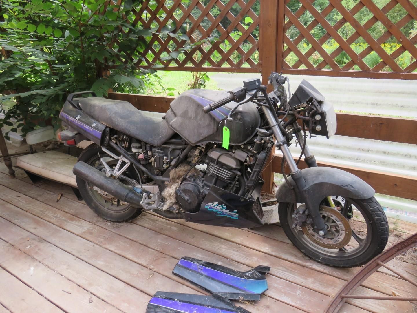 Motorcycle parked on a wooden deck.
