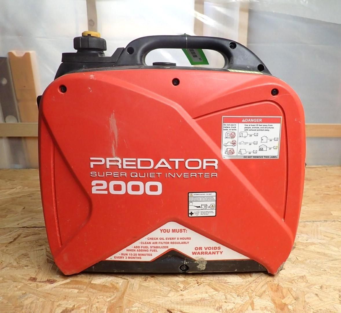 Red Predator 2000 Super Quiet Inverter generator with a black handle.