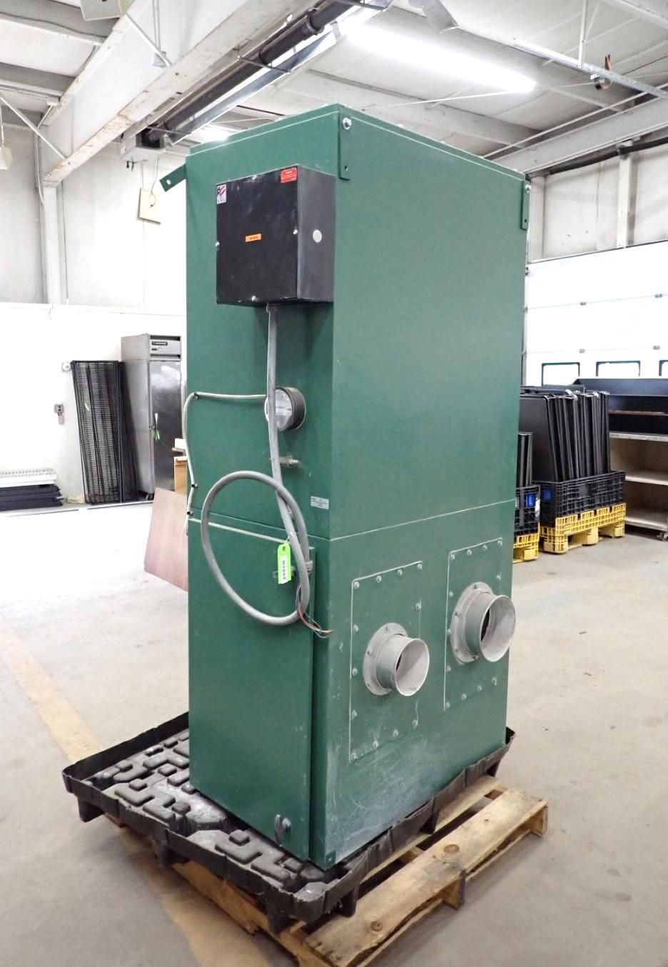 Green industrial air filtration unit with two circular vents, control panel, and piping on a pallet.