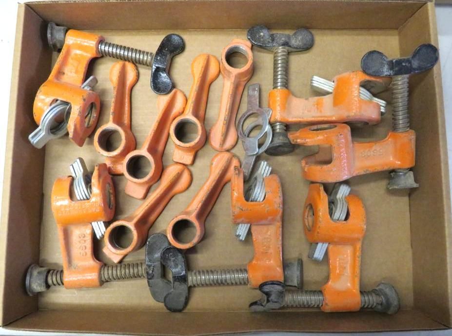 Box of orange pipe clamps and levers.