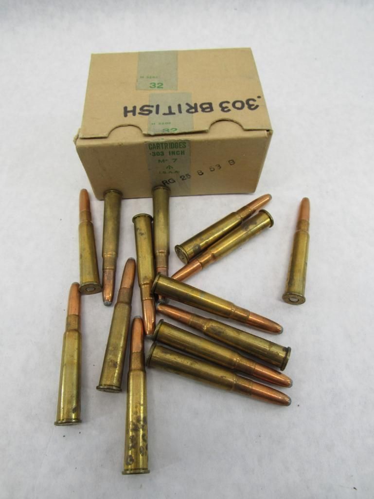 A box of .303 British ammunition with scattered cartridges. Golden casings, copper-tipped bullets.