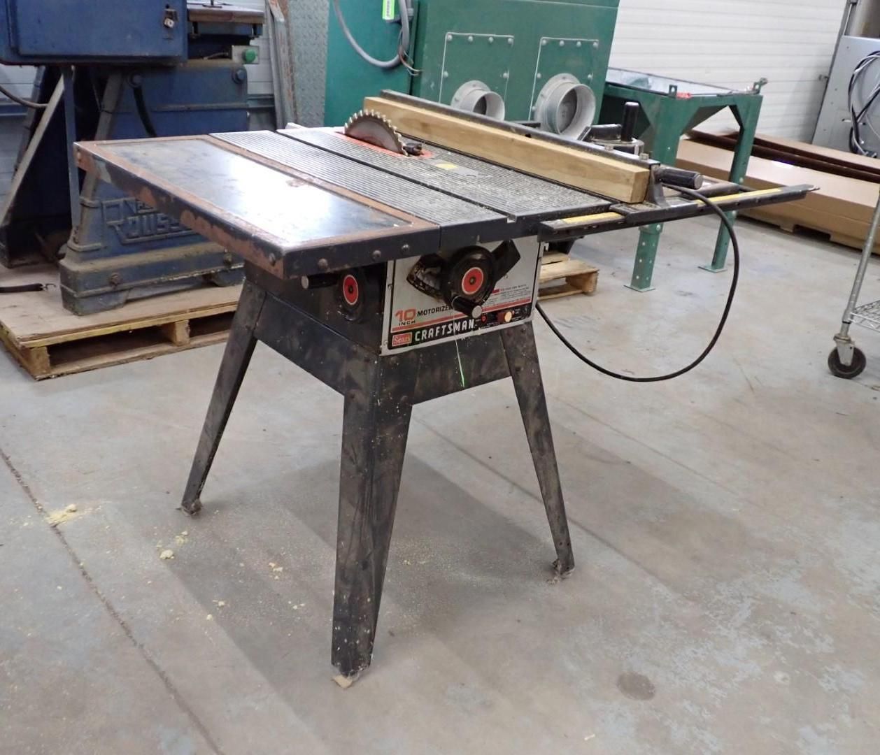 Black table saw in a workshop setting.