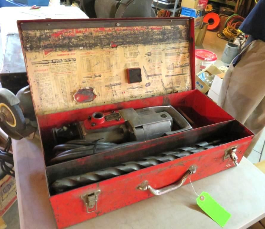 Red toolbox containing a drill and drill bits.