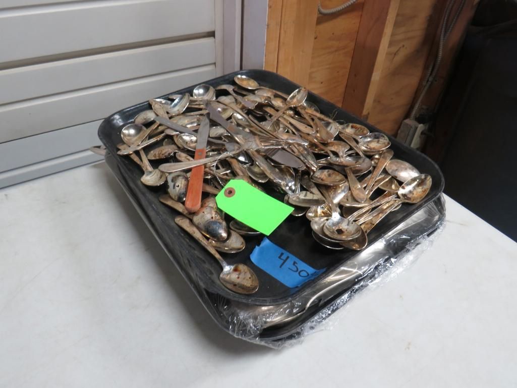 Tray filled with many spoons, various sizes. Green, orange, and blue price tags.