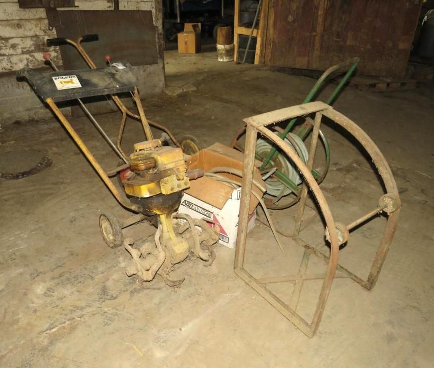 Yellow and black garden tiller with attachments.