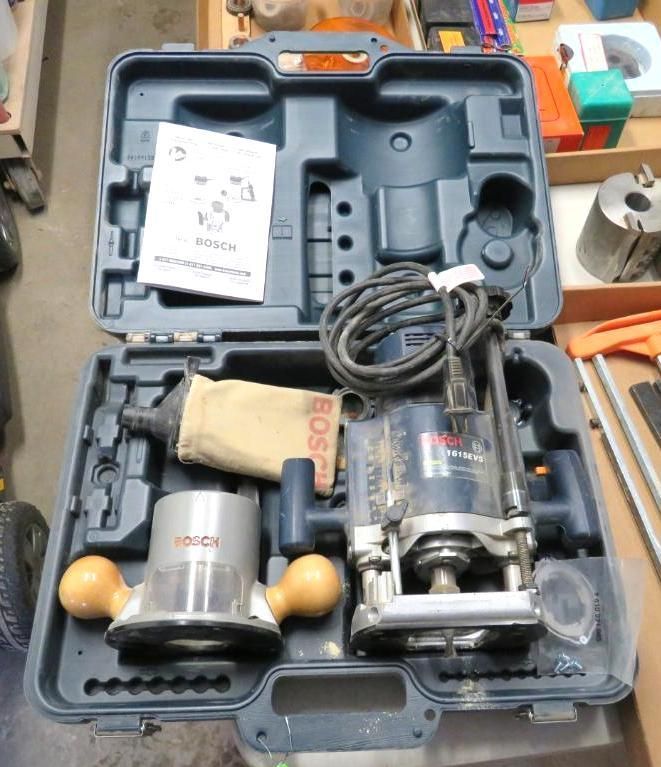 Bosch router kit in an open blue carrying case with accessories and manual.