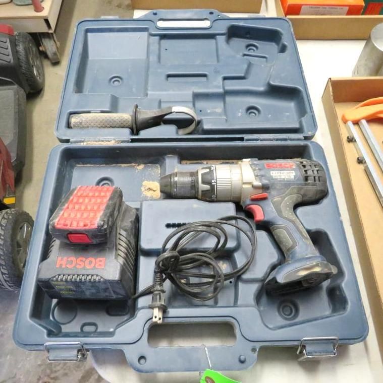 Blue Bosch drill, charger, and handle in a blue case.
