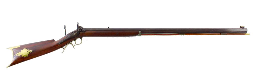 A long-barreled brown rifle with a star-shaped ornament on the wooden stock, set against a white background.