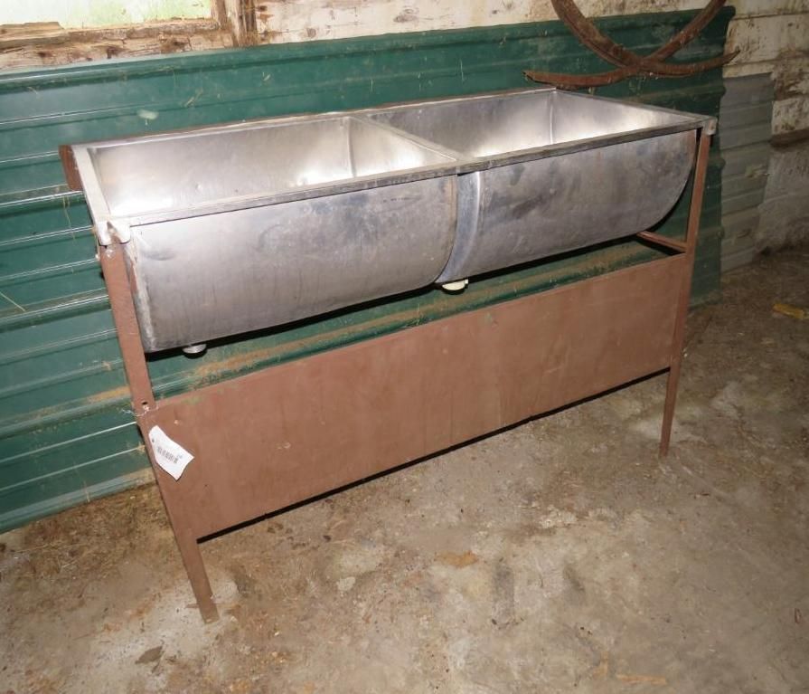 Metal trough on a brown stand. The trough has two compartments.