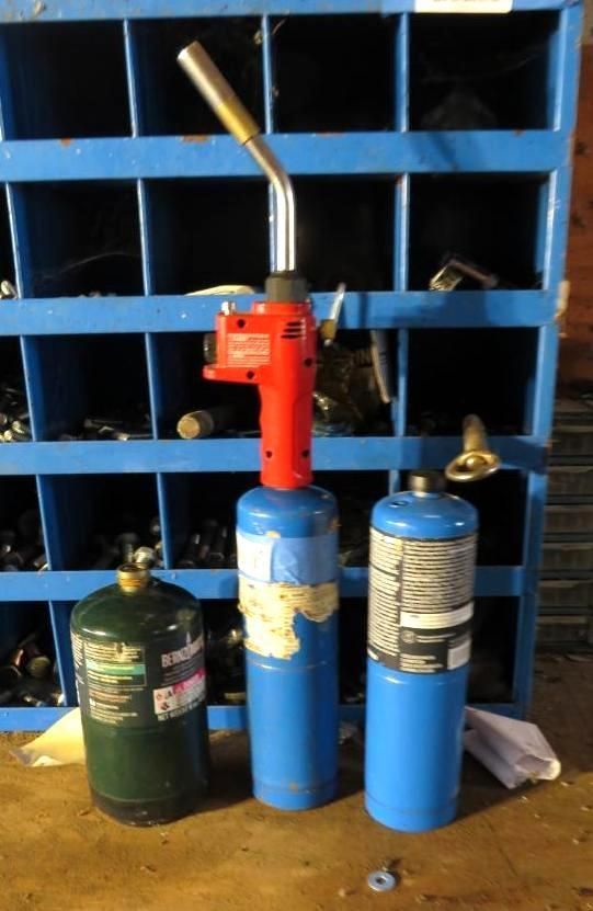Three propane torch tanks with a torch head.
