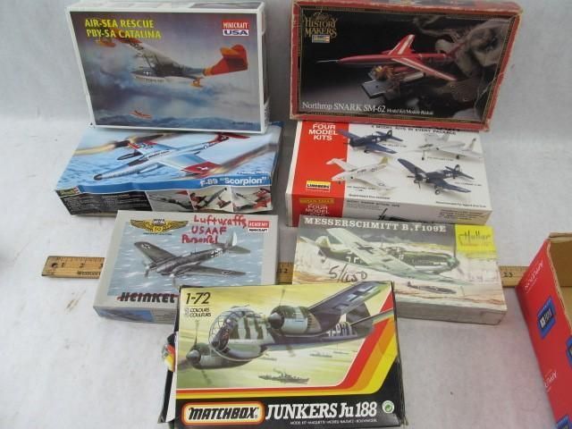 Collection of model airplane kits in boxes, depicting various aircraft.