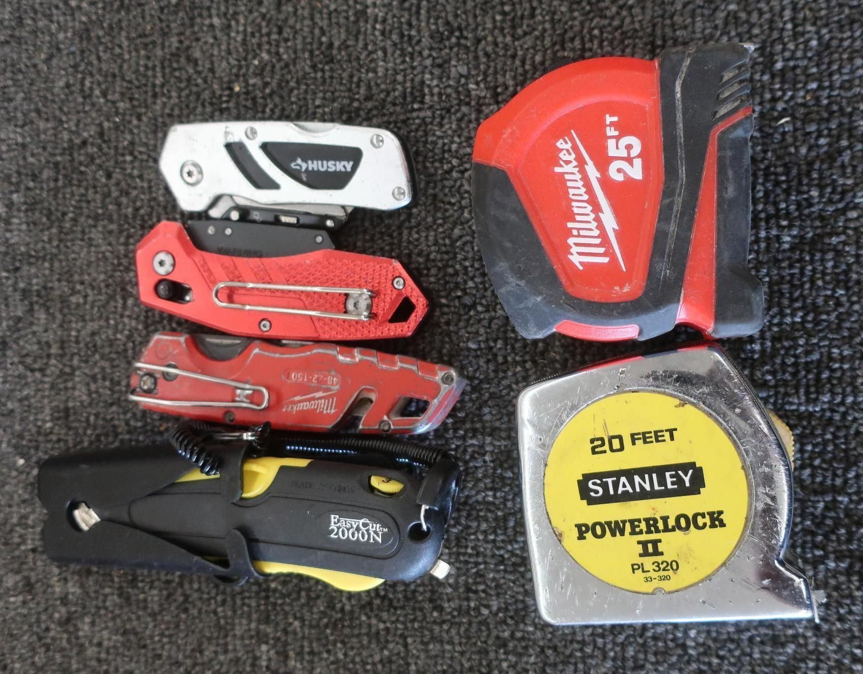 Various tools: Husky multi-tool, Milwaukee and Stanley tape measures, Mastercraft utility knife.