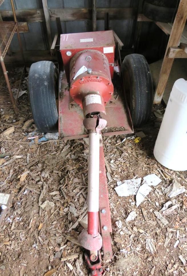 Red, wheeled agricultural PTO shaft assembly.