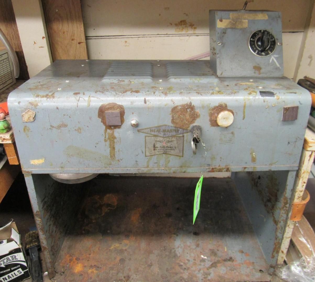 Metal industrial machine with a control box and a key in the lock.