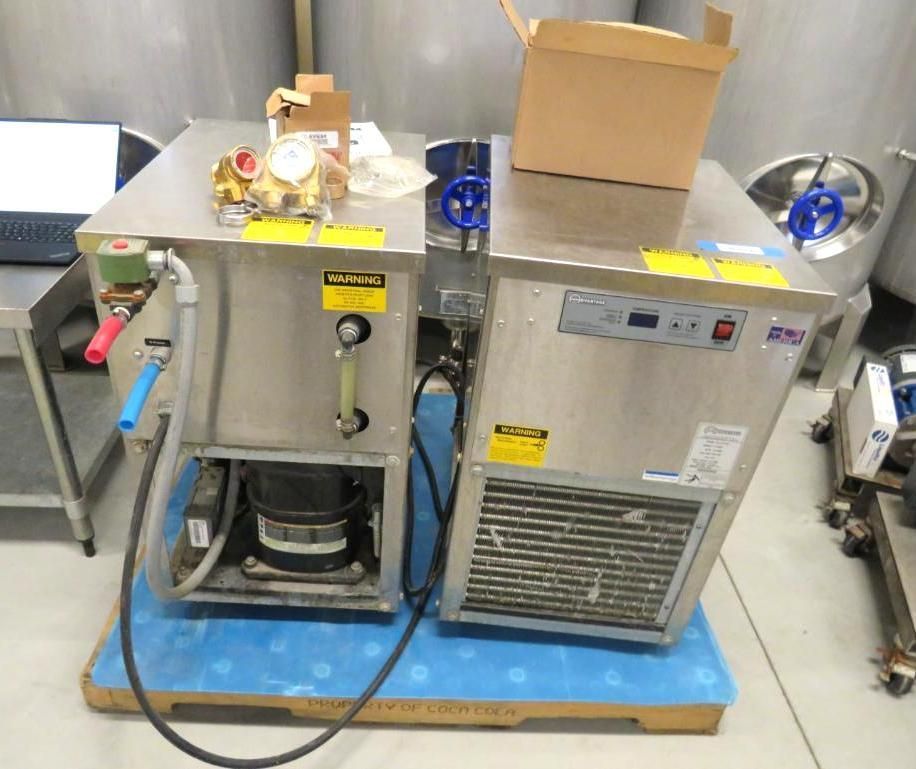 Stainless steel beer dispensing system on a pallet, with components and a box on top.