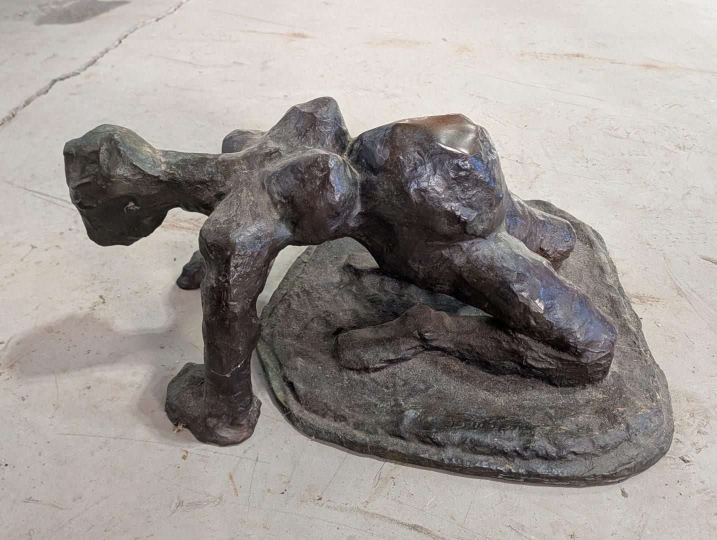 Bronze sculpture of a reclining nude figure on an oval base