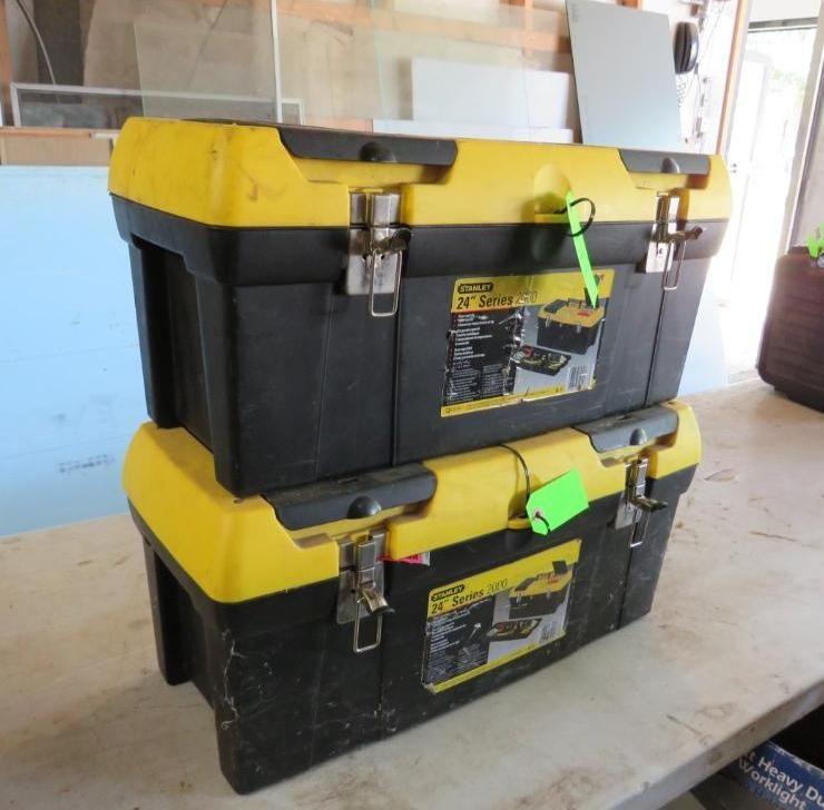 Two black and yellow Stanley toolboxes stacked on a surface, with latches and product labels.