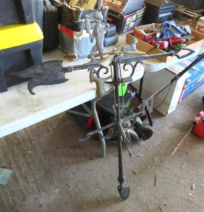 Black metal decorative weathervane with arrow-like head.