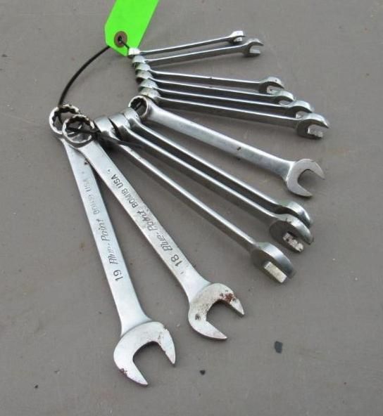 Set of open-end wrenches on a metal ring, organized by size, with a green tag.