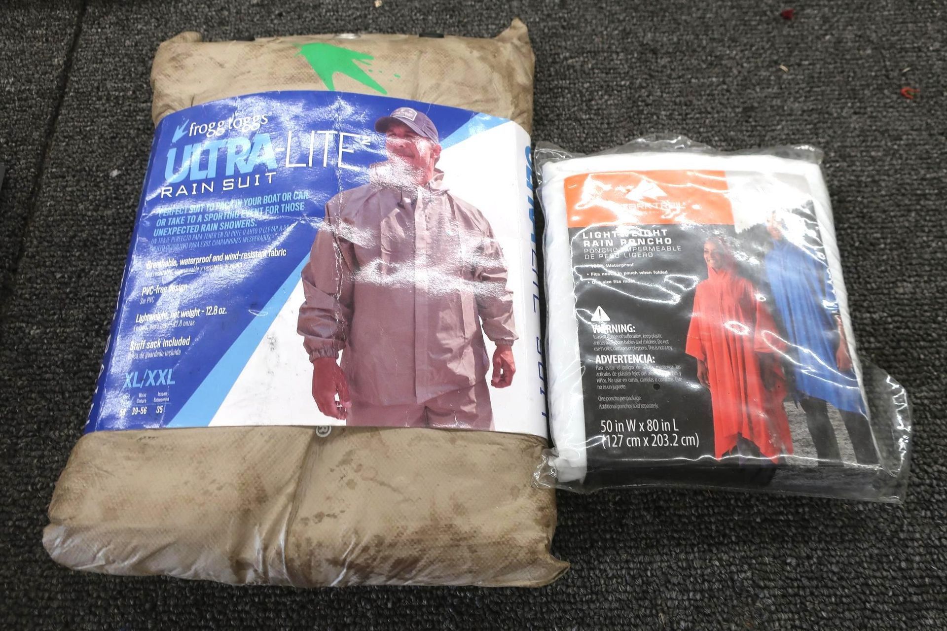 Two packages of rain gear: one large brown suit package and one smaller multi-colored poncho package.