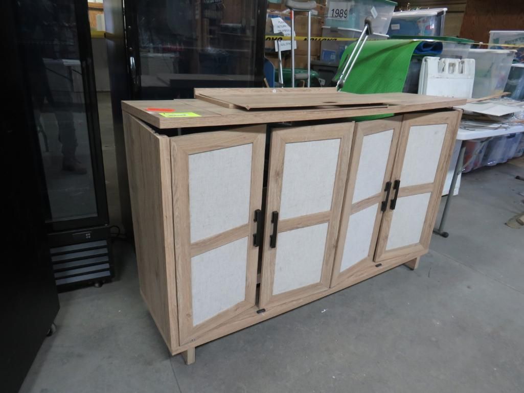 Wooden cabinet with four doors; beige frame, white panels, black handles.