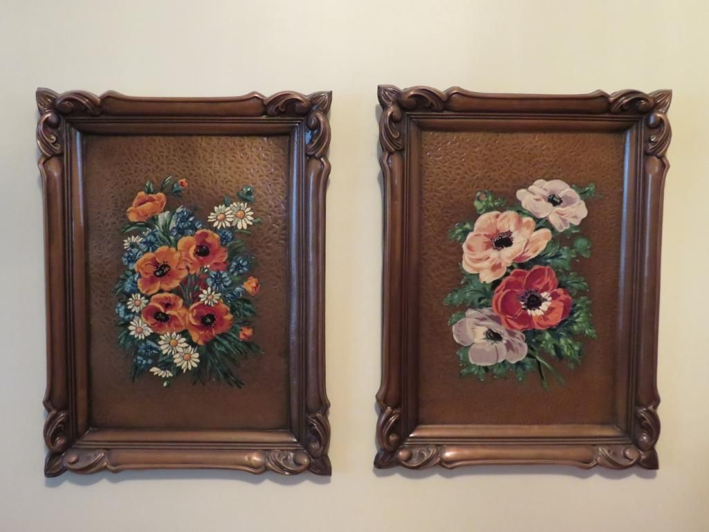 Two framed floral needlepoint art pieces with brown textured backgrounds and ornately carved brown frames.