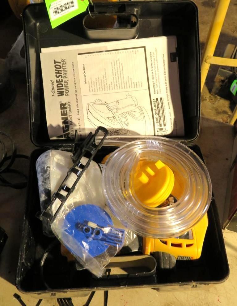 A black case containing a yellow and black Wagner Wideshot portable paint sprayer and accessories.