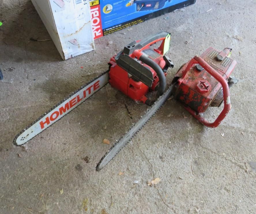 Two red chainsaws on a concrete surface, one labeled