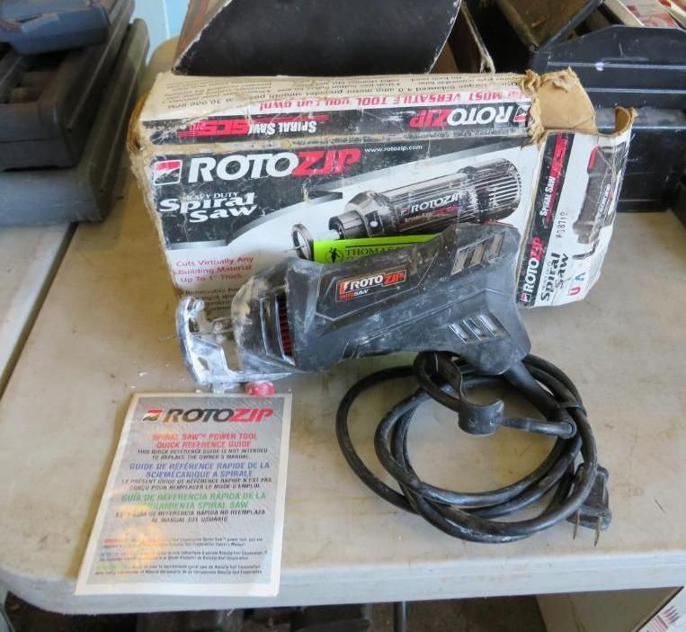 RotoZip spiral saw with its box and paperwork on a light-colored table.